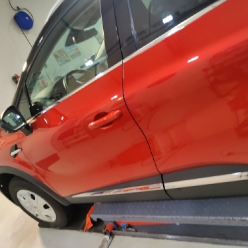 Rød bil klargjort til keramisk coating behandling i værksted