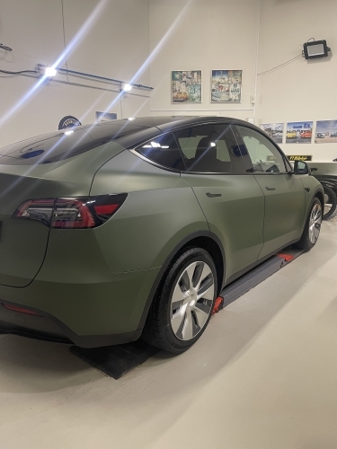 Bilpleje og rengøring – Tesla Model 3 med mat grøn lakfinish i værksted